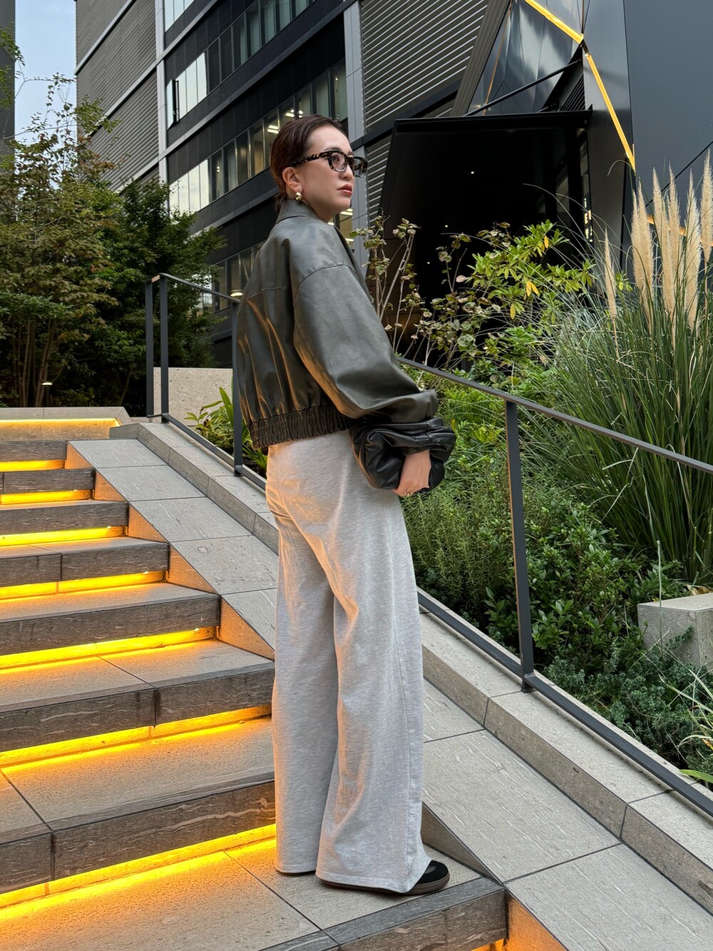 グリーン系のブルゾンを着用したレディースの秋コーディネートの2枚目の写真