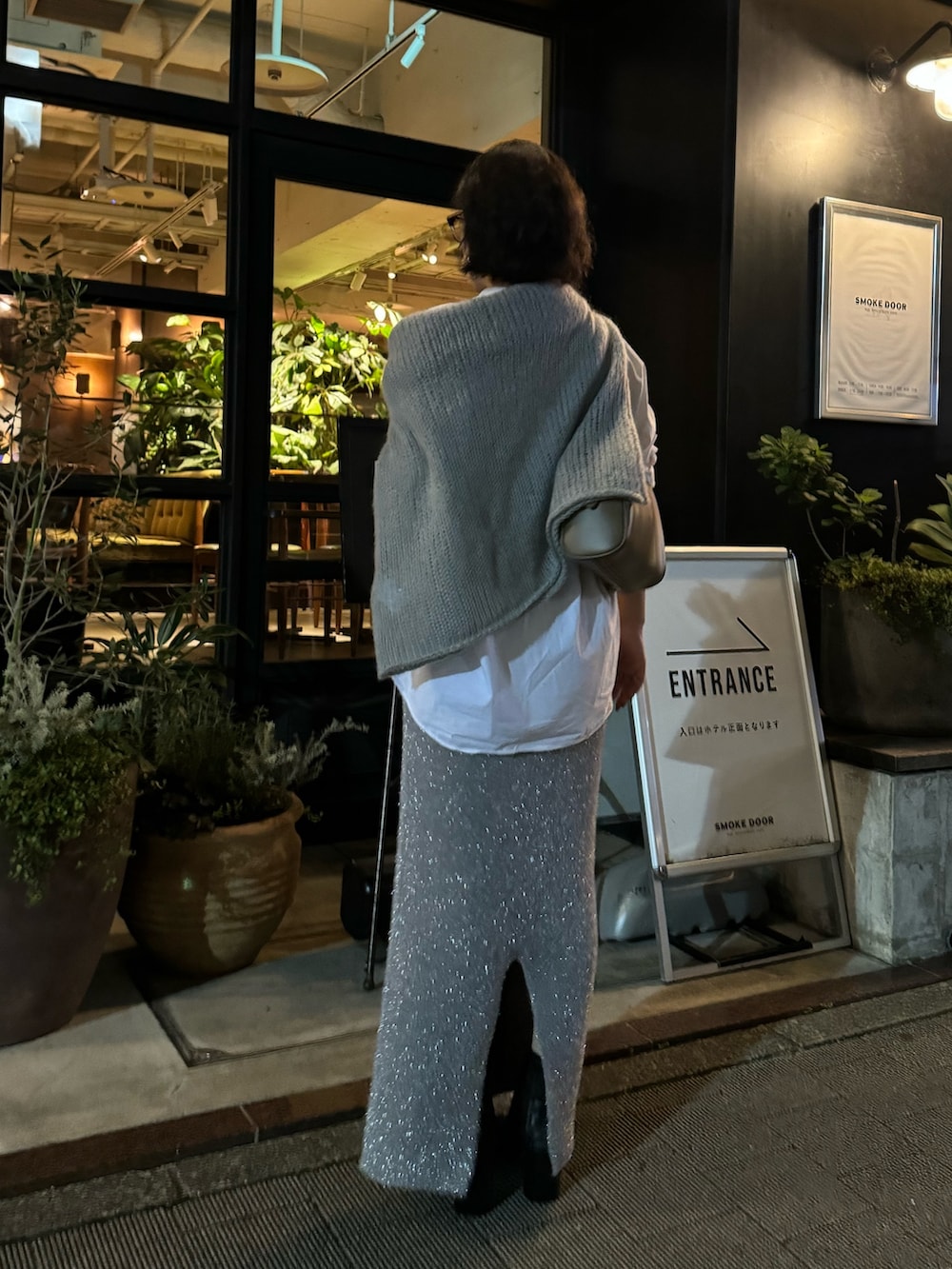 シルバー系のスカートを着用したレディースの秋コーディネートの3枚目の写真