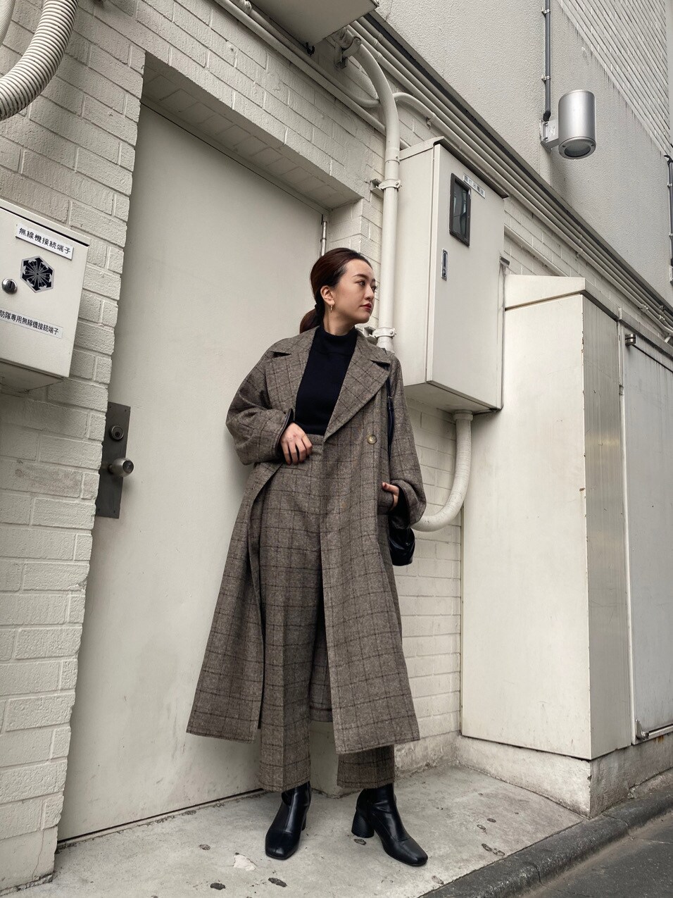 その他のダウンジャケット/コート、ブラック系のニット/セーター、ブラック系のハンドバッグを着用したレディースの秋コーディネートの3枚目の写真