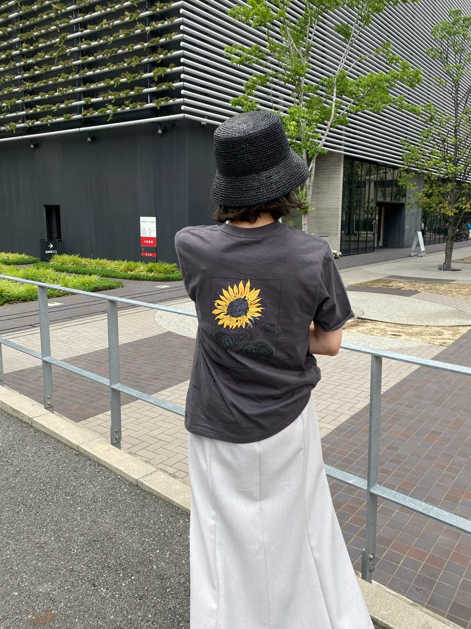 ブラック系のサンダル、ホワイト系のスカート、グレー系のTシャツ/カットソーを着用したレディースの夏コーディネートの4枚目の写真