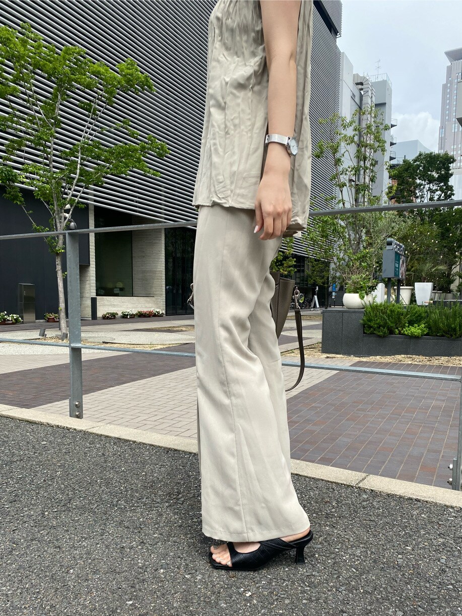 ベージュ系のシャツ/ブラウス、ブラック系のサンダル、ベージュ系のスラックスを着用したレディースの夏コーディネートの7枚目の写真