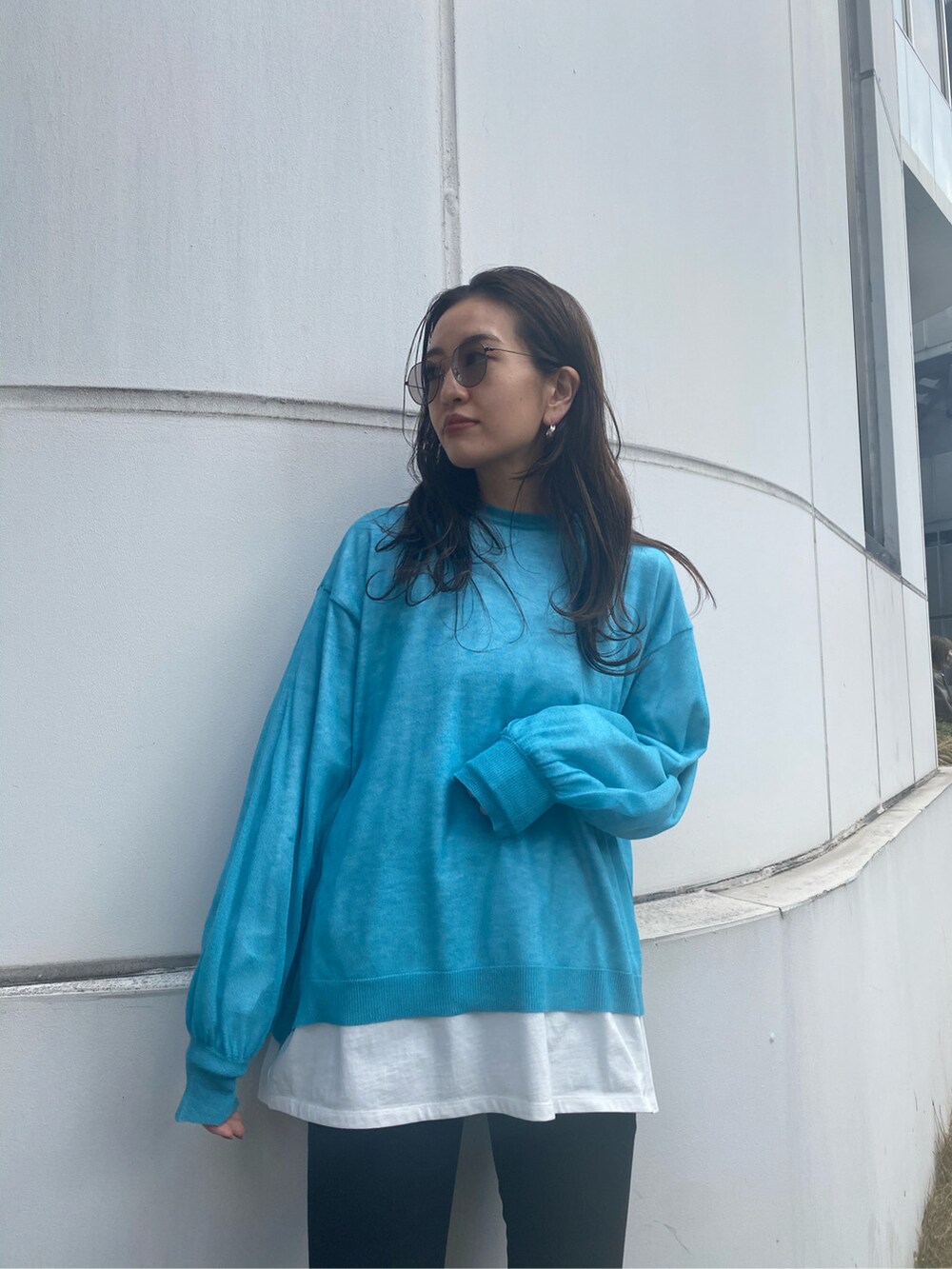 ブラック系のデニムパンツ、ブラック系のサンダル、ブルー系のニット/セーターを着用したレディースの冬コーディネートの3枚目の写真