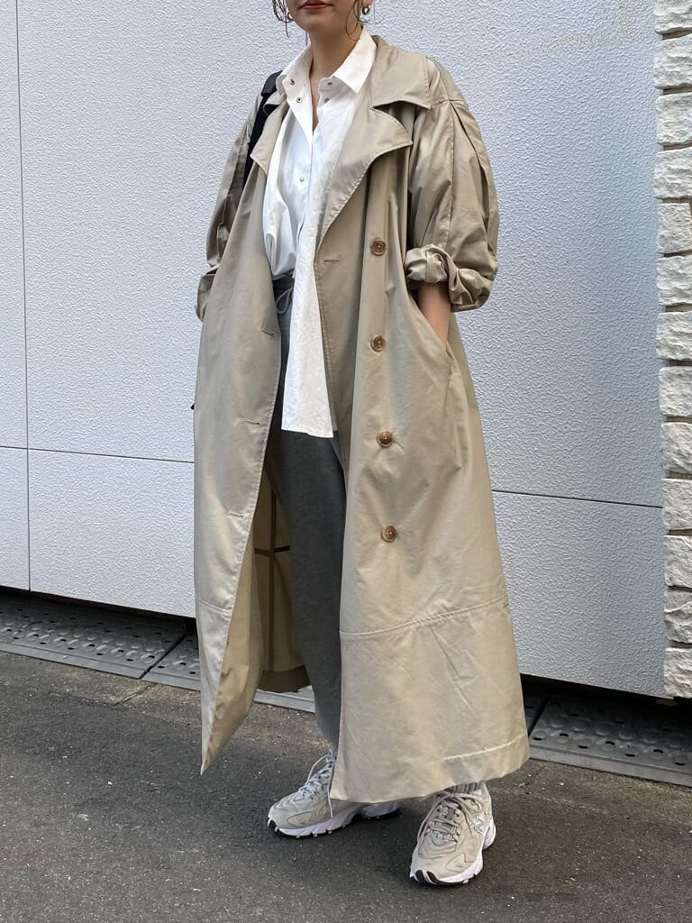 ベージュ系のトレンチコートを着用したレディースの春コーディネートの5枚目の写真