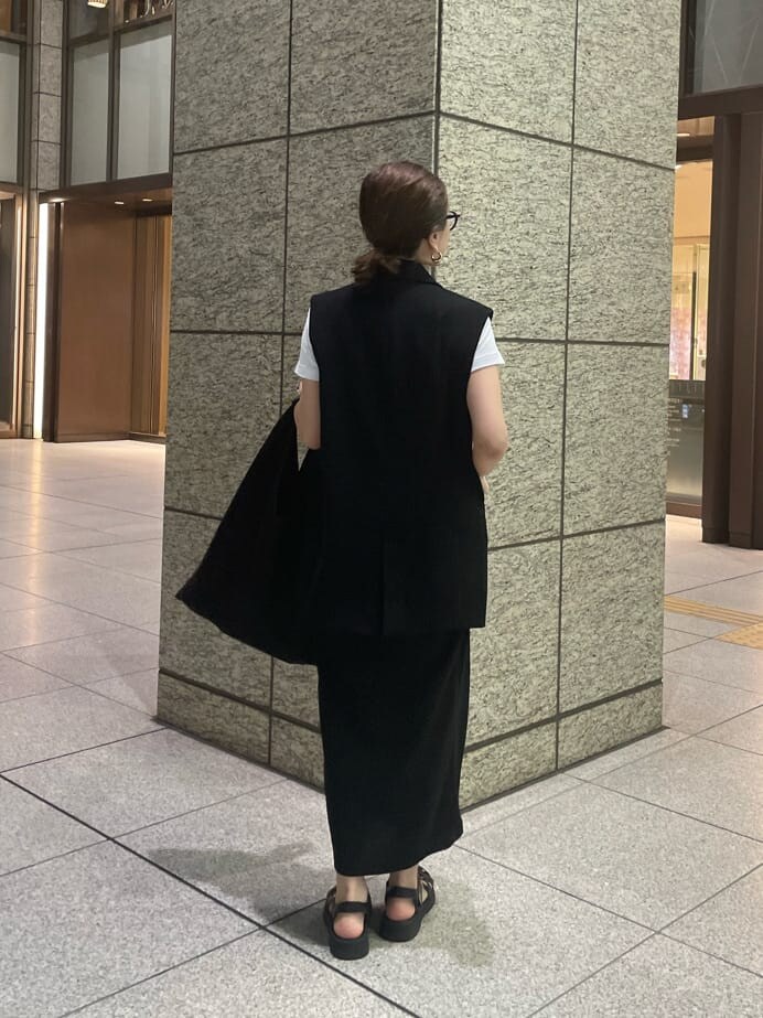 ブラック系のスカート、ゴールド系のピアス（両耳用）を着用したレディースの夏コーディネートの4枚目の写真