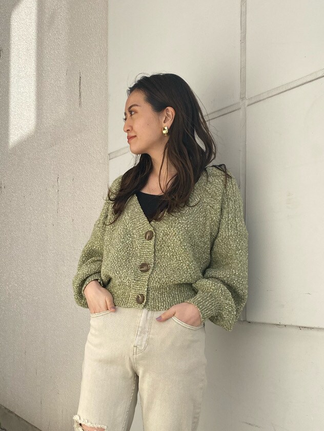 グリーン系のカーディガン/ボレロ、ホワイト系のパンプス、ゴールド系のイヤリングを着用したレディースの冬コーディネートの3枚目の写真