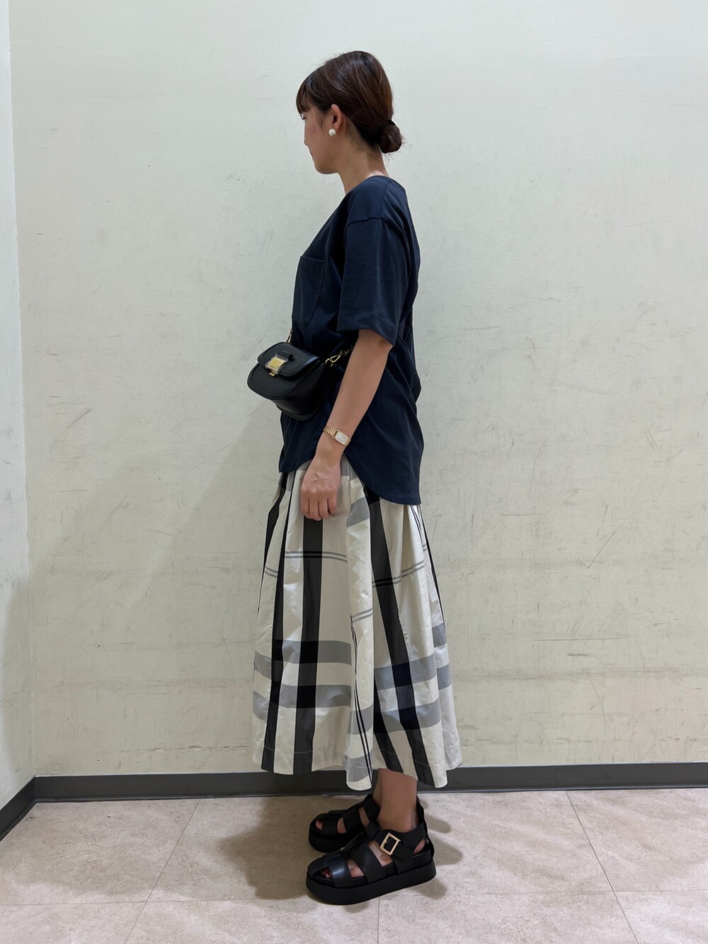 ブルー系のTシャツ/カットソー、ブラック系のボディバッグ/ウエストポーチ、ホワイト系のスカートを着用したレディースの夏コーディネートの3枚目の写真