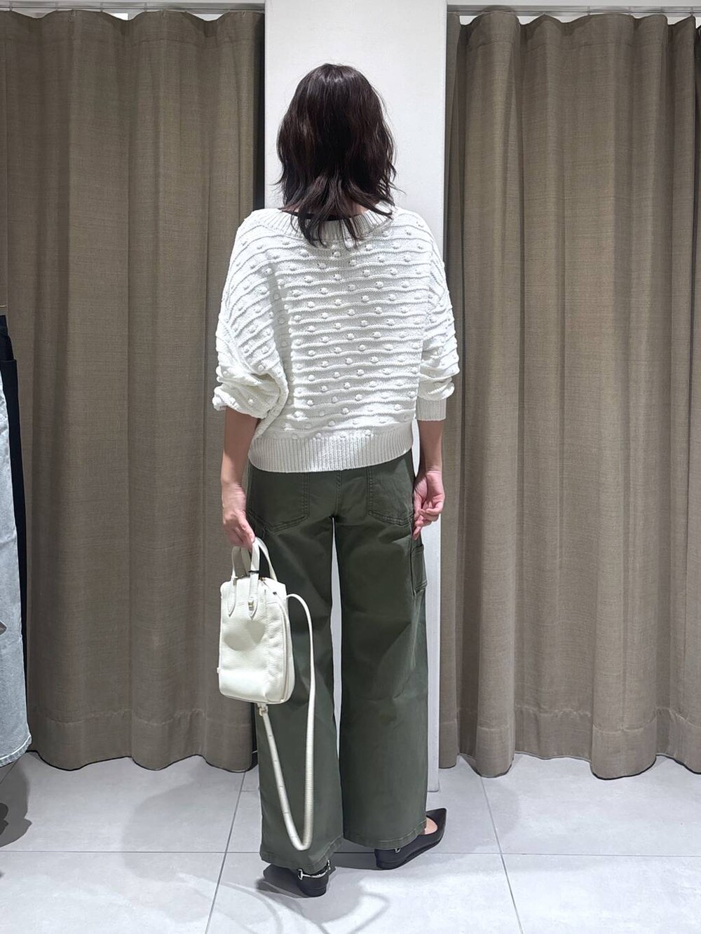 ホワイト系のニット/セーター、グリーン系のその他パンツ、ホワイト系のショルダーバッグを着用したレディースの冬コーディネートの3枚目の写真