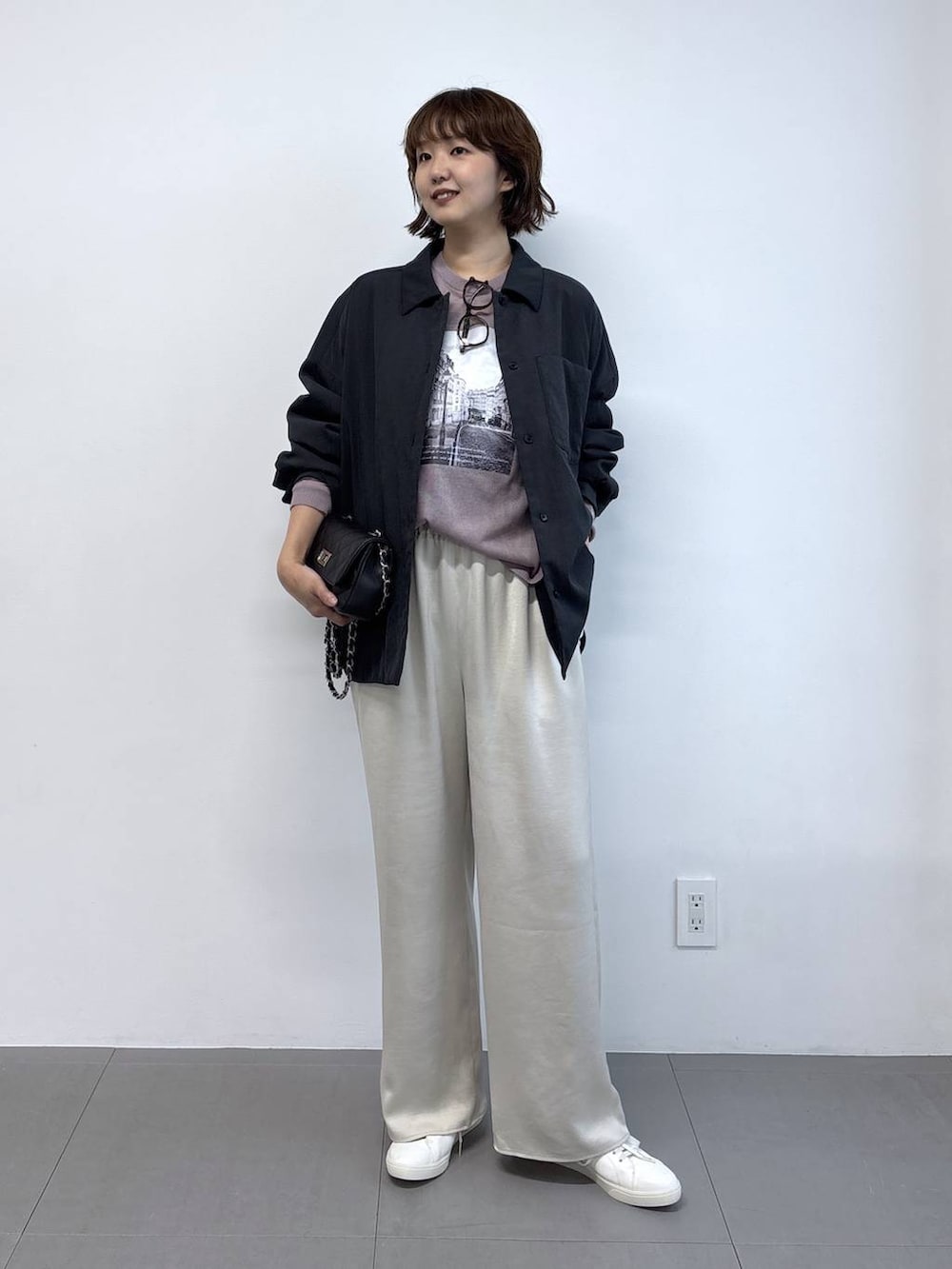 ピンク系のニット/セーター、ブラック系のハンドバッグ、ブラック系のブルゾンを着用したレディースの秋コーディネートの6枚目の写真