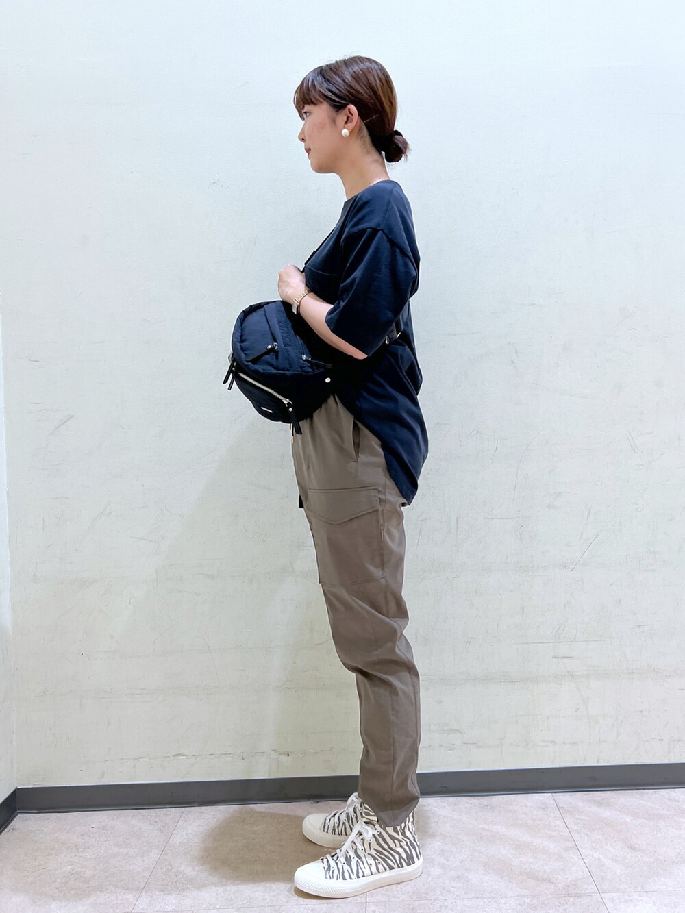 ブルー系のTシャツ/カットソー、ブラック系のボディバッグ/ウエストポーチ、グリーン系のカーゴパンツを着用したレディースの夏コーディネートの2枚目の写真