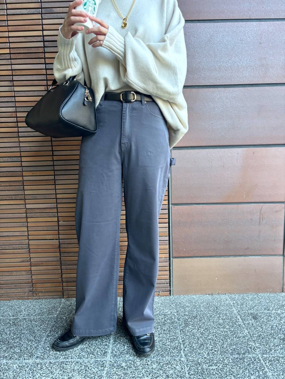 ブラック系のボストンバッグ、ホワイト系のニット/セーター、グレー系のその他パンツを着用したレディースの冬コーディネートの4枚目の写真