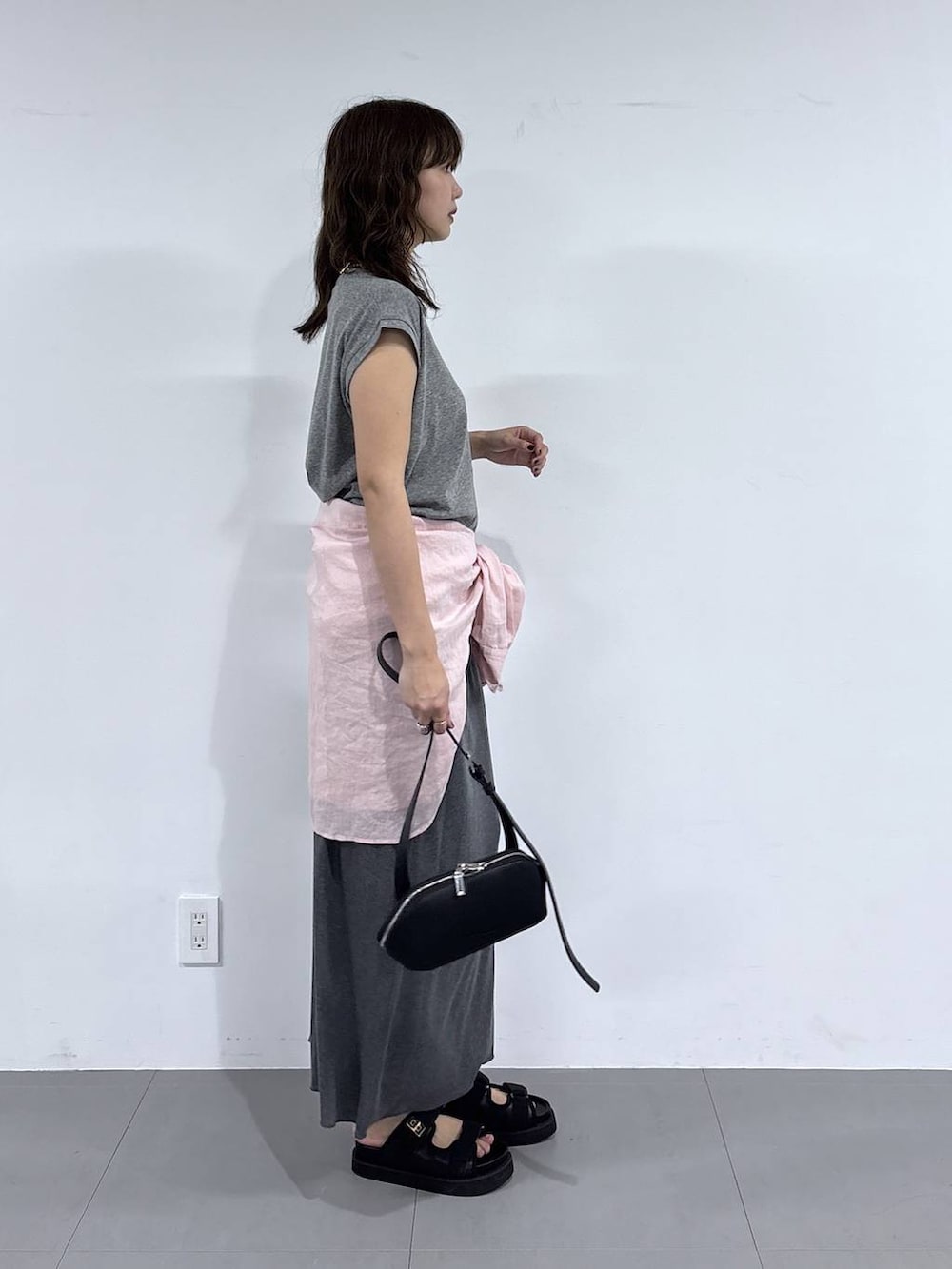 ブラック系のショルダーバッグ、ピンク系のシャツ/ブラウス、ブラック系のサンダルを着用したレディースの春コーディネートの4枚目の写真