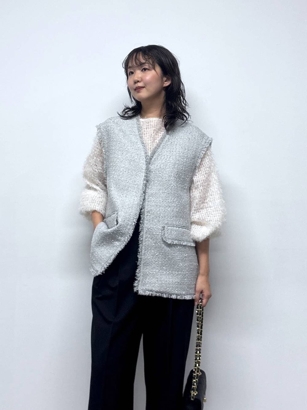 ホワイト系のシャツ/ブラウス、グレー系のその他アウター、ブラック系のショルダーバッグを着用したレディースの冬コーディネートの3枚目の写真