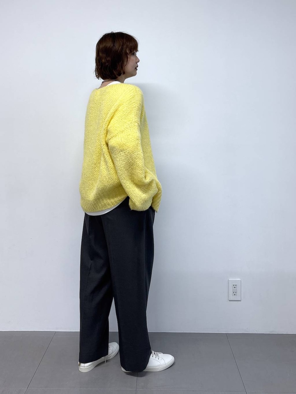 ホワイト系のTシャツ/カットソー、ブラウン系のボストンバッグ、イエロー系のカーディガン/ボレロを着用したレディースの秋コーディネートの4枚目の写真