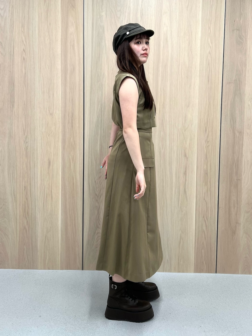 ブラウン系のブーツ、グリーン系のワンピース、ベージュ系のキャスケットを着用したレディースの夏コーディネートの6枚目の写真