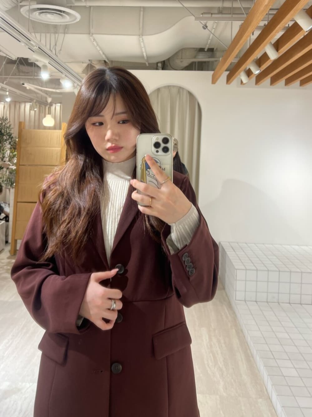 レッド系のスカート、レッド系のテーラードジャケット、ブラック系のブーツを着用したレディースの秋コーディネートの6枚目の写真