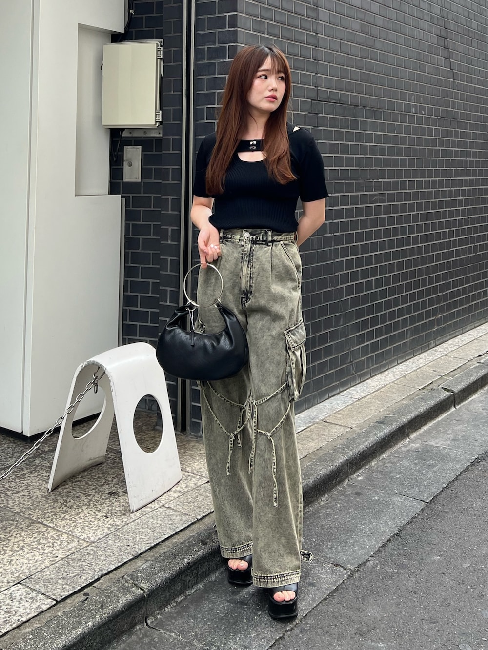 ブラック系のサンダル、ブラック系のハンドバッグ、ブラック系のニット/セーターを着用したレディースの夏コーディネートの7枚目の写真