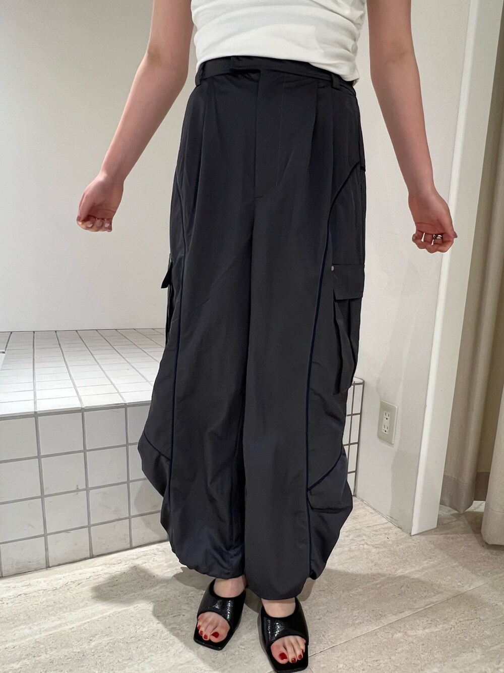 ブラック系のパンプス、グレー系のカーゴパンツ、ホワイト系のTシャツ/カットソーを着用したレディースの夏コーディネートの4枚目の写真