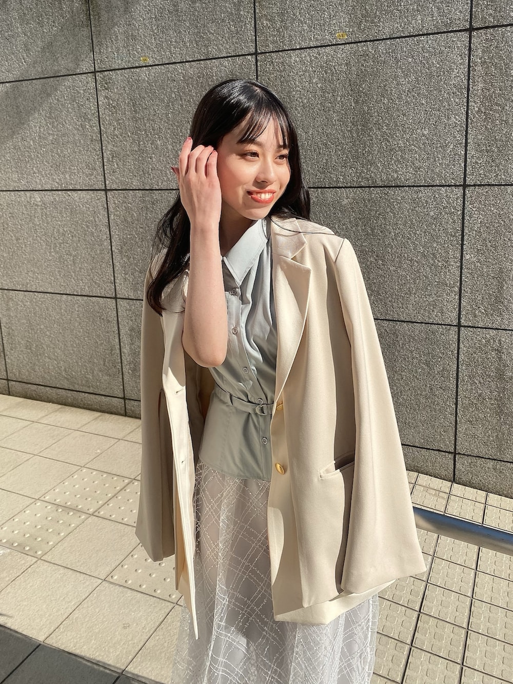 ブルー系のワンピース、ホワイト系のテーラードジャケットを着用したレディースの冬コーディネートの7枚目の写真