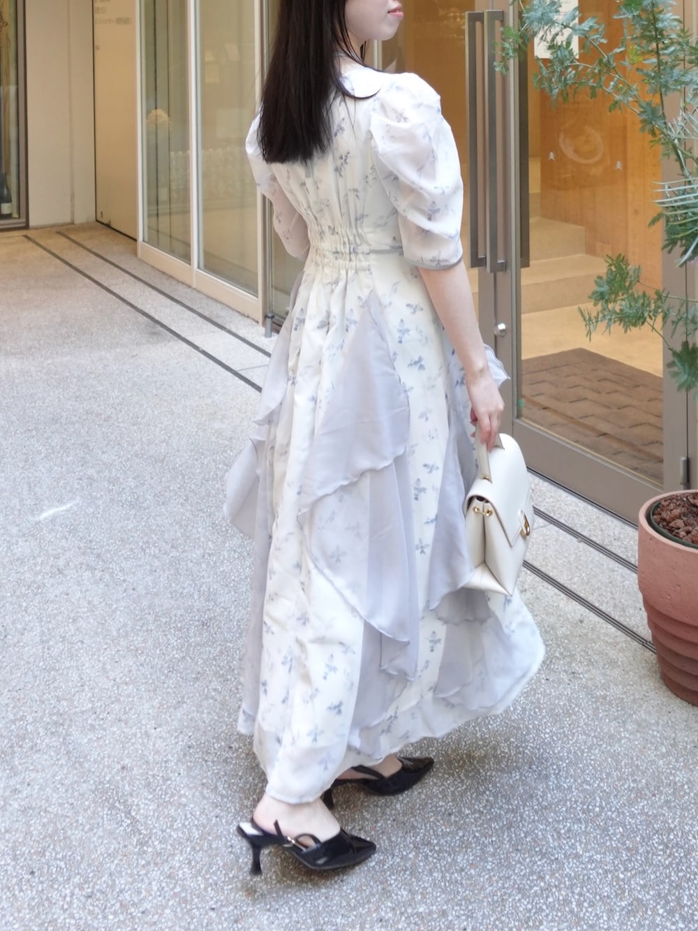 ブルー系のワンピースを着用したレディースの春コーディネートの2枚目の写真