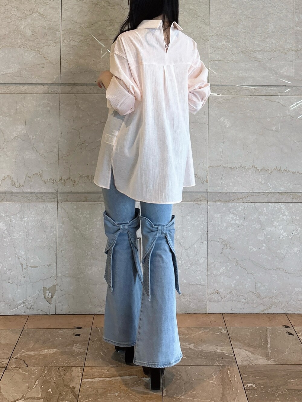 ブラック系のブーツ、ブルー系のデニムパンツ、ピンク系のシャツ/ブラウスを着用したレディースの春コーディネートの3枚目の写真