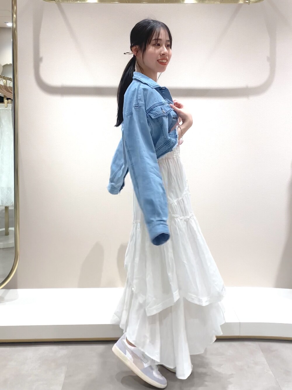 ホワイト系のスカート、パープル系のTシャツ/カットソー、ブルー系のブルゾンを着用したレディースの春コーディネートの4枚目の写真