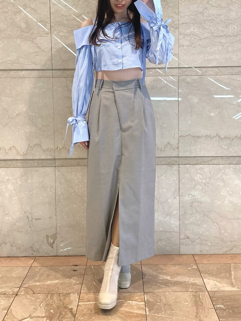 グレー系のスカート、ブルー系のシャツ/ブラウスを着用したレディースの冬コーディネートの2枚目の写真