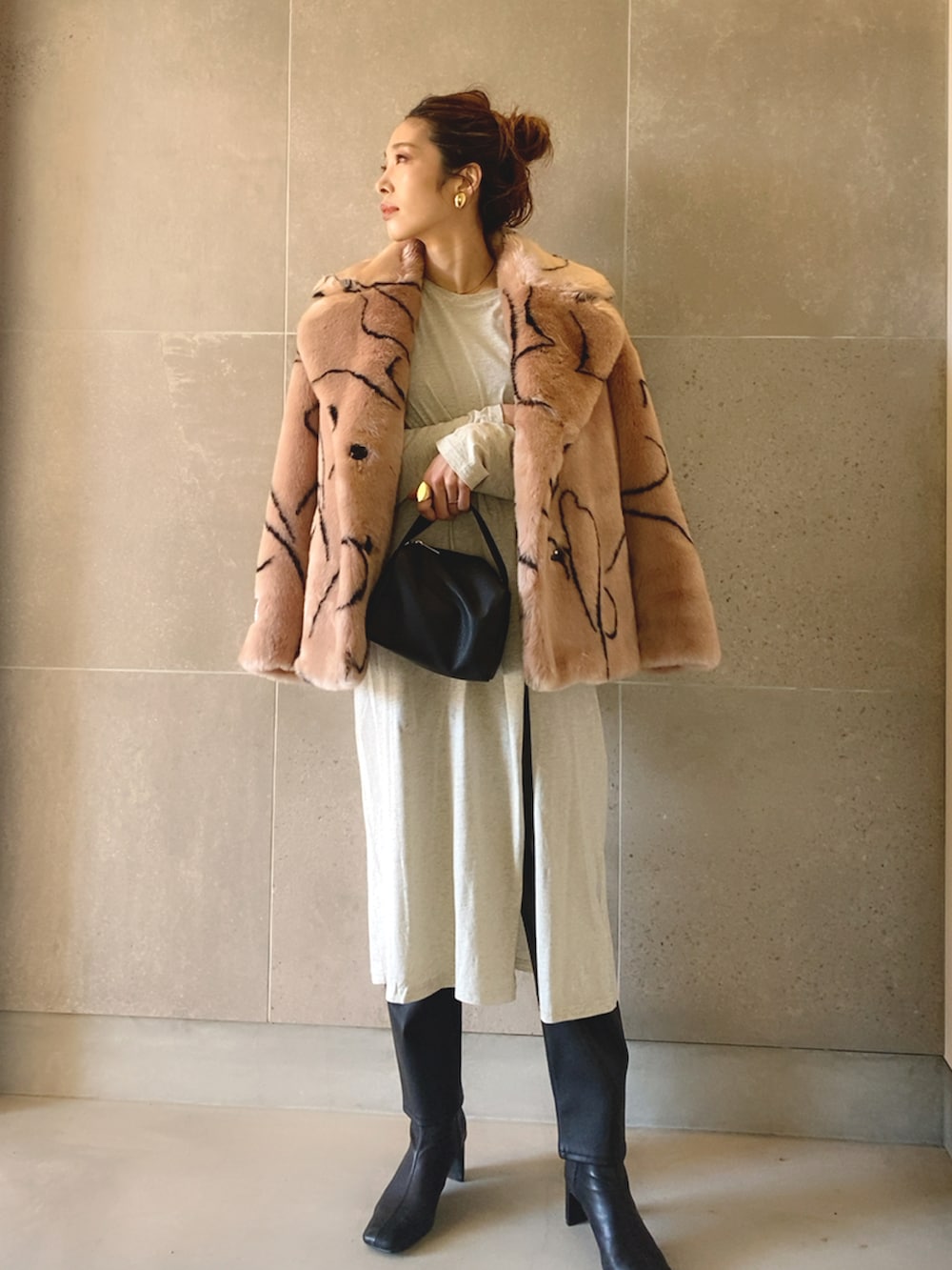 ピンク系のブルゾン、グレー系のワンピース、ブラック系のその他パンツを着用したレディースの冬コーディネートの2枚目の写真