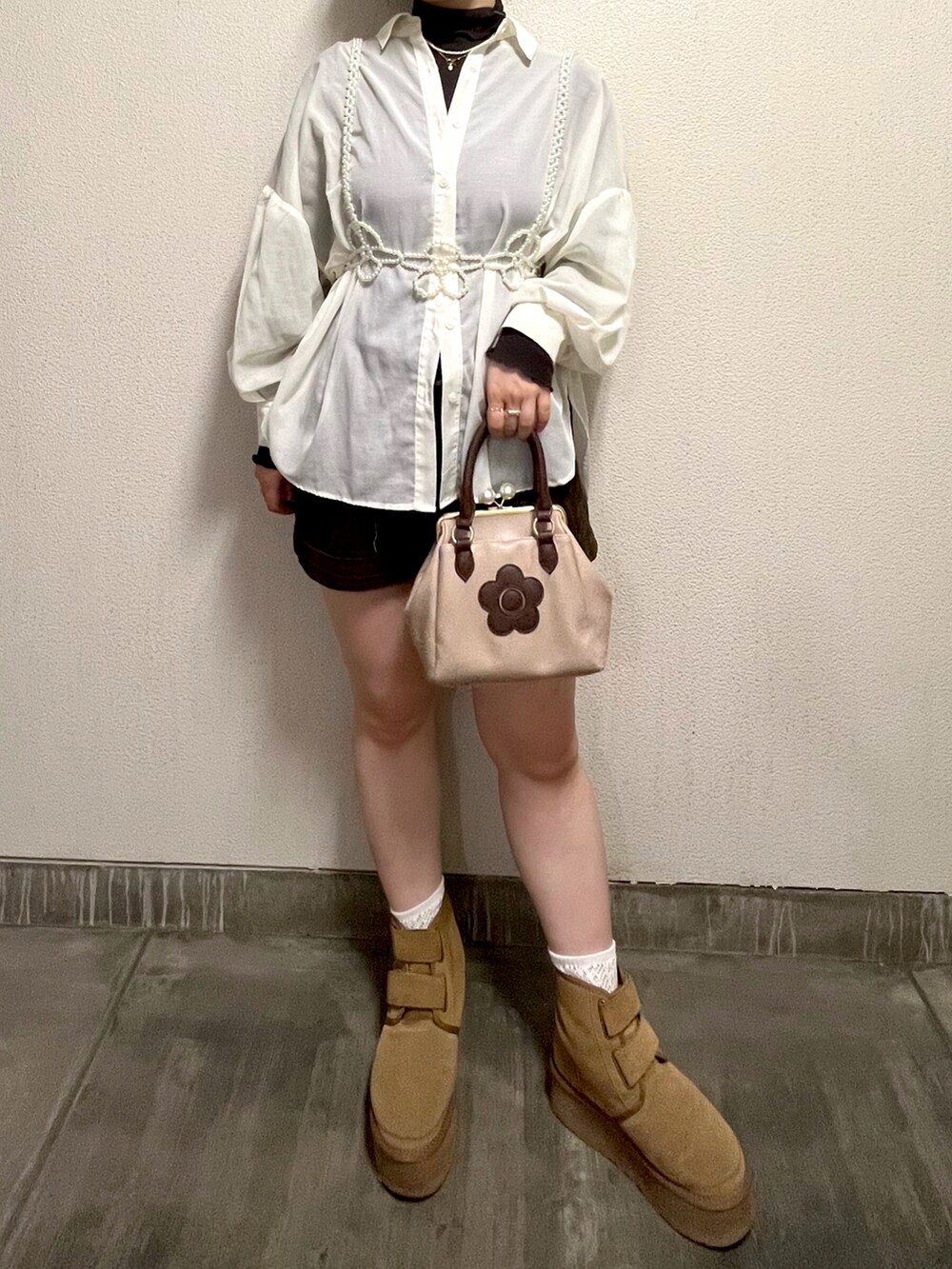 ブラウン系のTシャツ/カットソー、ホワイト系のシャツ/ブラウス、ブラウン系のショルダーバッグを着用したレディースの秋コーディネートの3枚目の写真
