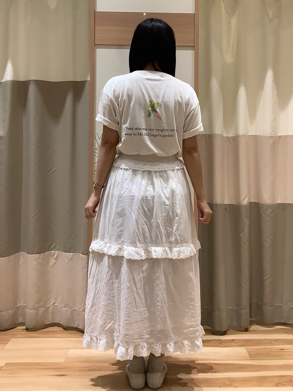 ホワイト系のスカート、ホワイト系のTシャツ/カットソー、ホワイト系のパンプスを着用したレディースの春コーディネートの3枚目の写真