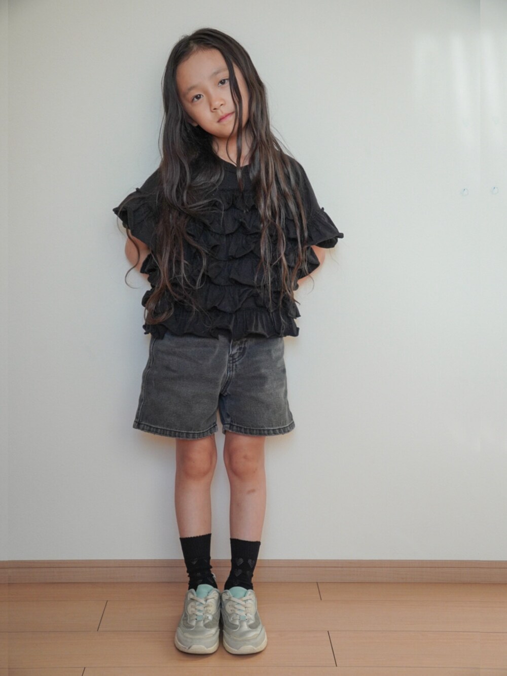 ブラック系のTシャツ/カットソー、ブラック系のデニムパンツ、シルバー系のスニーカーを着用したキッズの秋コーディネートの3枚目の写真