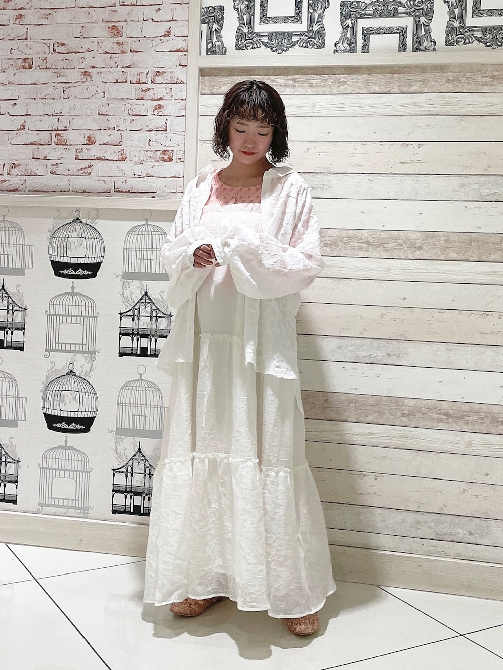 ピンク系のTシャツ/カットソー、ホワイト系のシャツ/ブラウス、ホワイト系のワンピースを着用したレディースの春コーディネートの2枚目の写真