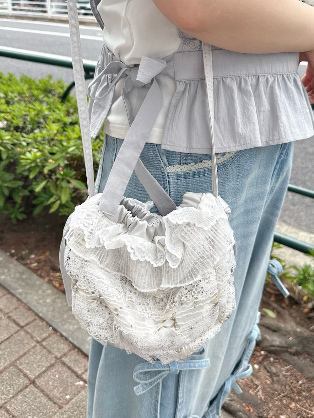 ブルー系のショルダーバッグ、ブルー系のシャツ/ブラウス、ホワイト系のTシャツ/カットソーを着用したレディースの春コーディネートの5枚目の写真