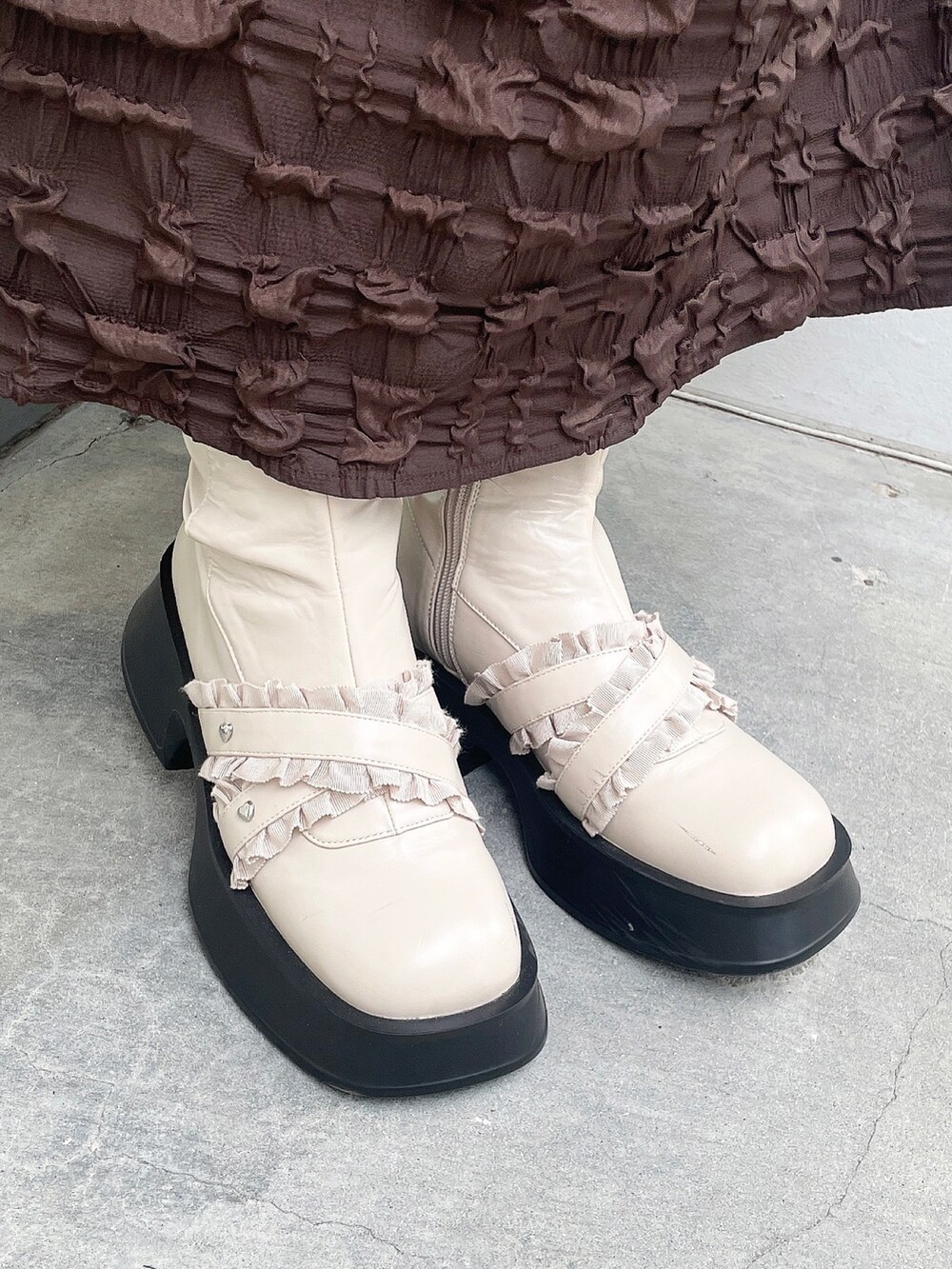 ピンク系のニット/セーター、ホワイト系のカーディガン/ボレロ、ブラウン系のワンピースを着用したレディースの秋コーディネートの9枚目の写真