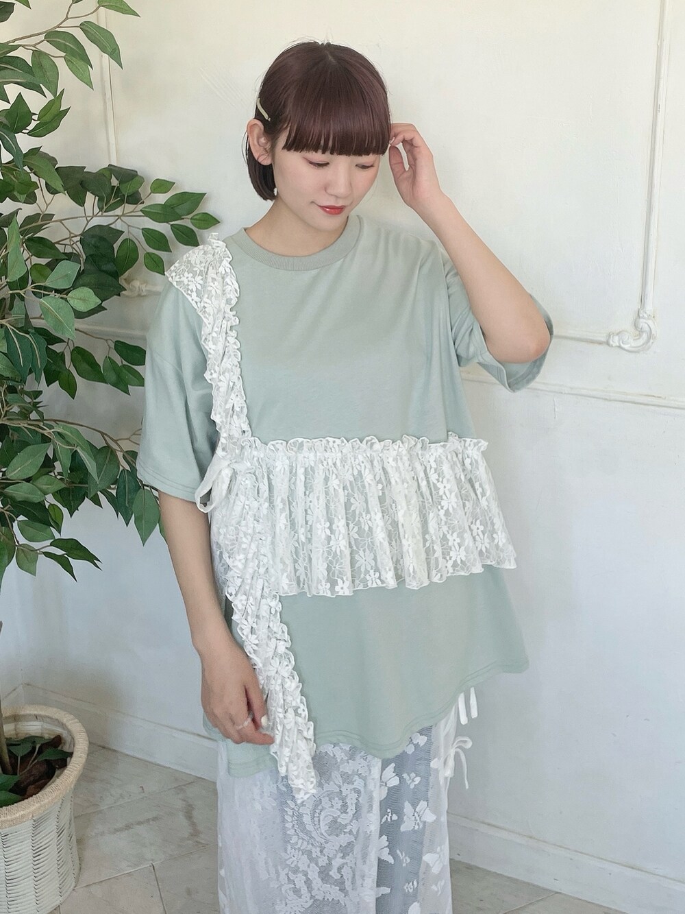 グリーン系のTシャツ/カットソー、ブルー系のデニムパンツ、ホワイト系のスカートを着用したレディースの春コーディネートの5枚目の写真