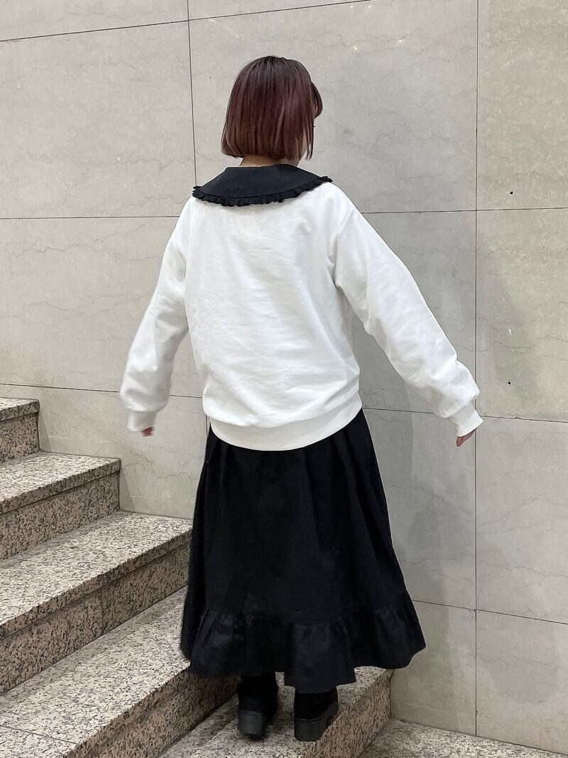 ブラック系のブーツ、ブラック系のワンピース、ホワイト系のTシャツ/カットソーを着用したレディースの冬コーディネートの3枚目の写真