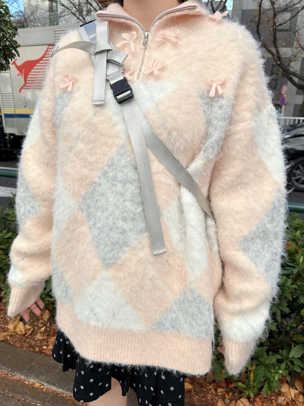 ピンク系のニット/セーター、グレー系のショルダーバッグ、ブラック系のスカートを着用したレディースの冬コーディネートの5枚目の写真