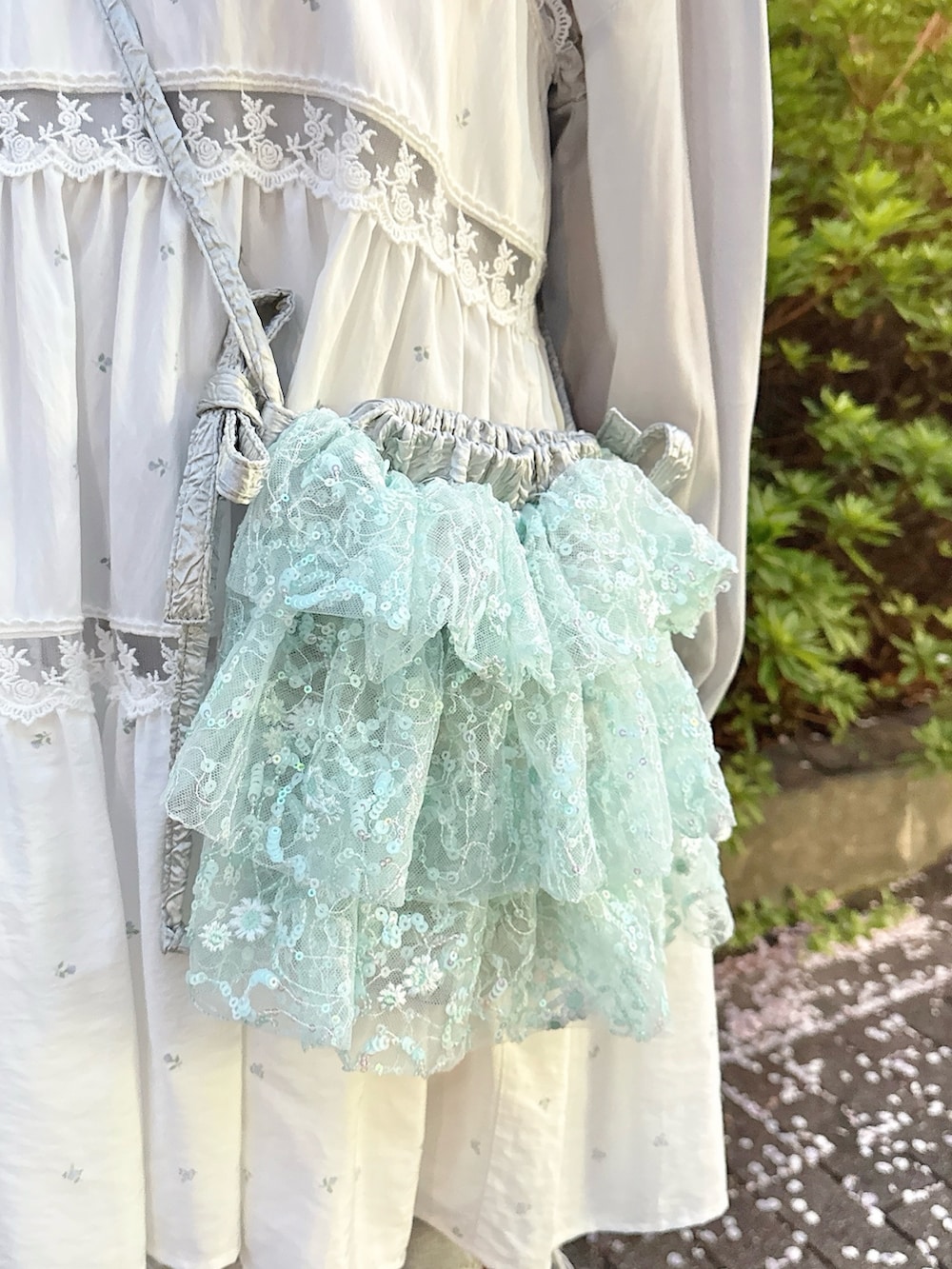 ブルー系のキャミソール、ブルー系のシャツ/ブラウス、ブルー系のショルダーバッグを着用したレディースの春コーディネートの6枚目の写真