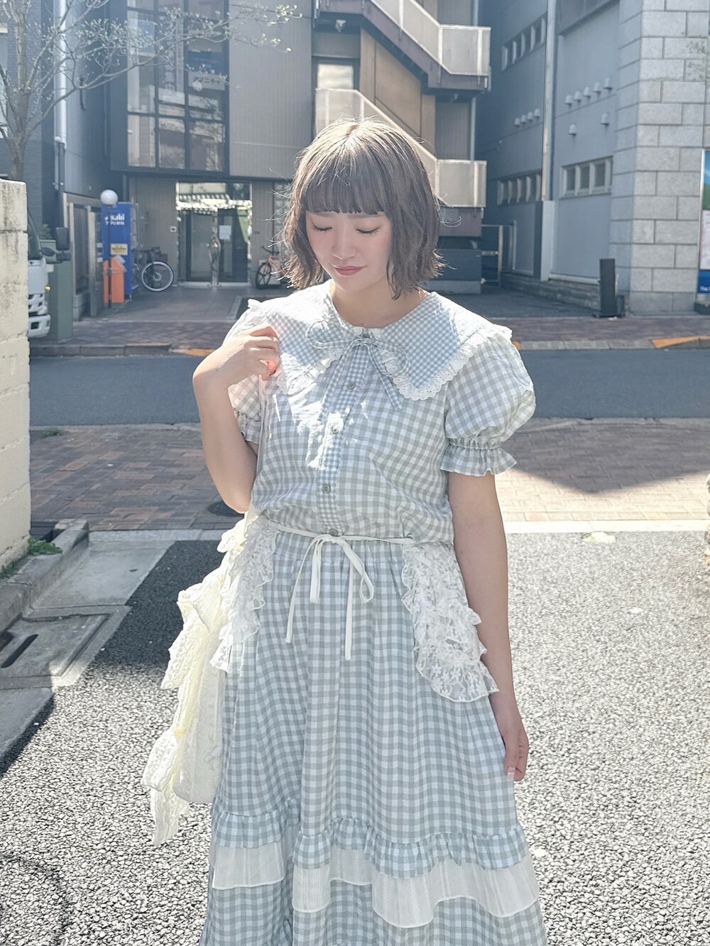 グリーン系のスカート、グリーン系のシャツ/ブラウス、ホワイト系のトートバッグを着用したレディースの春コーディネートの5枚目の写真