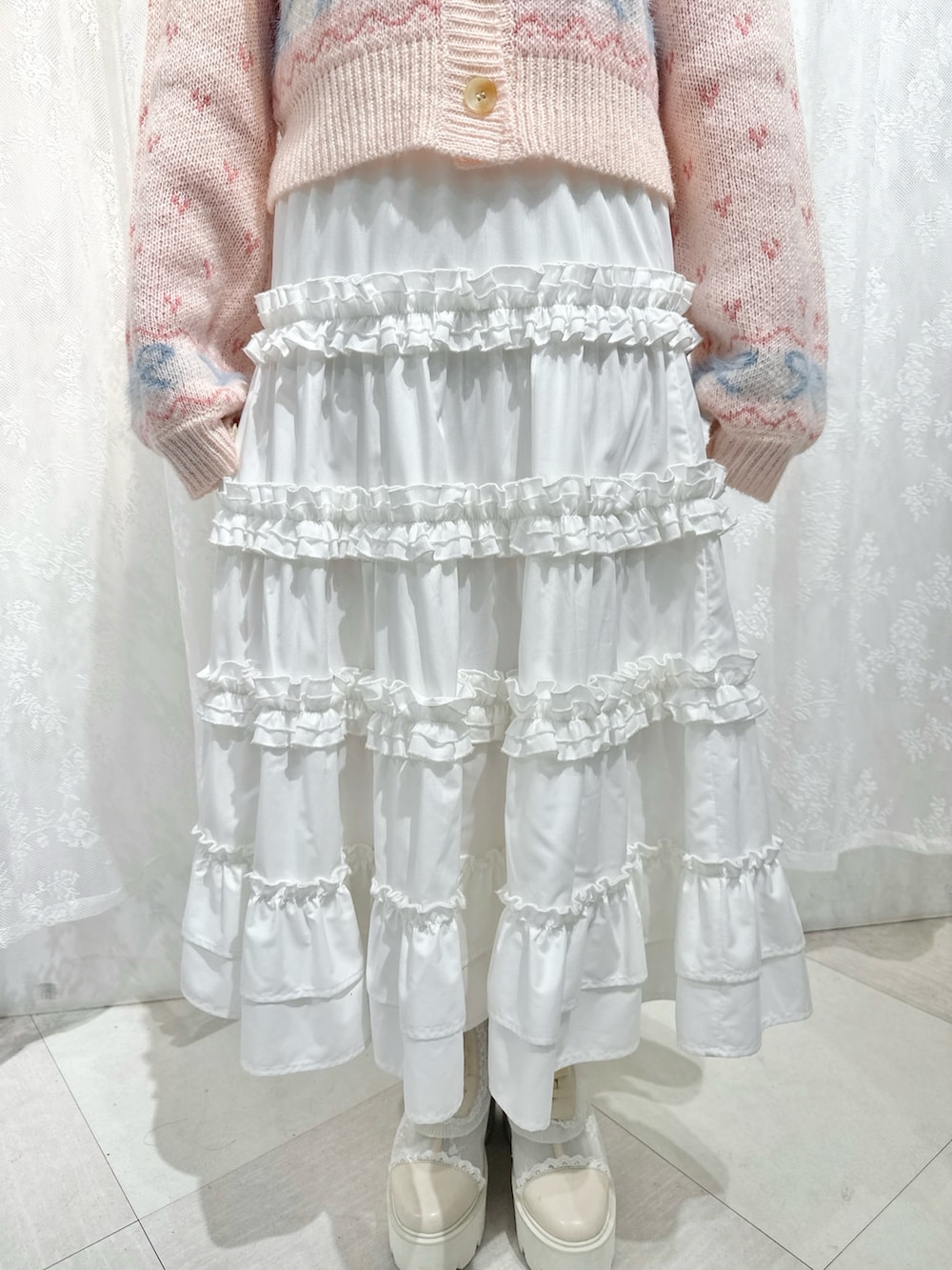 ピンク系のカーディガン/ボレロ、ホワイト系のスカート、ブラウン系のハンドバッグを着用したレディースの夏コーディネートの8枚目の写真