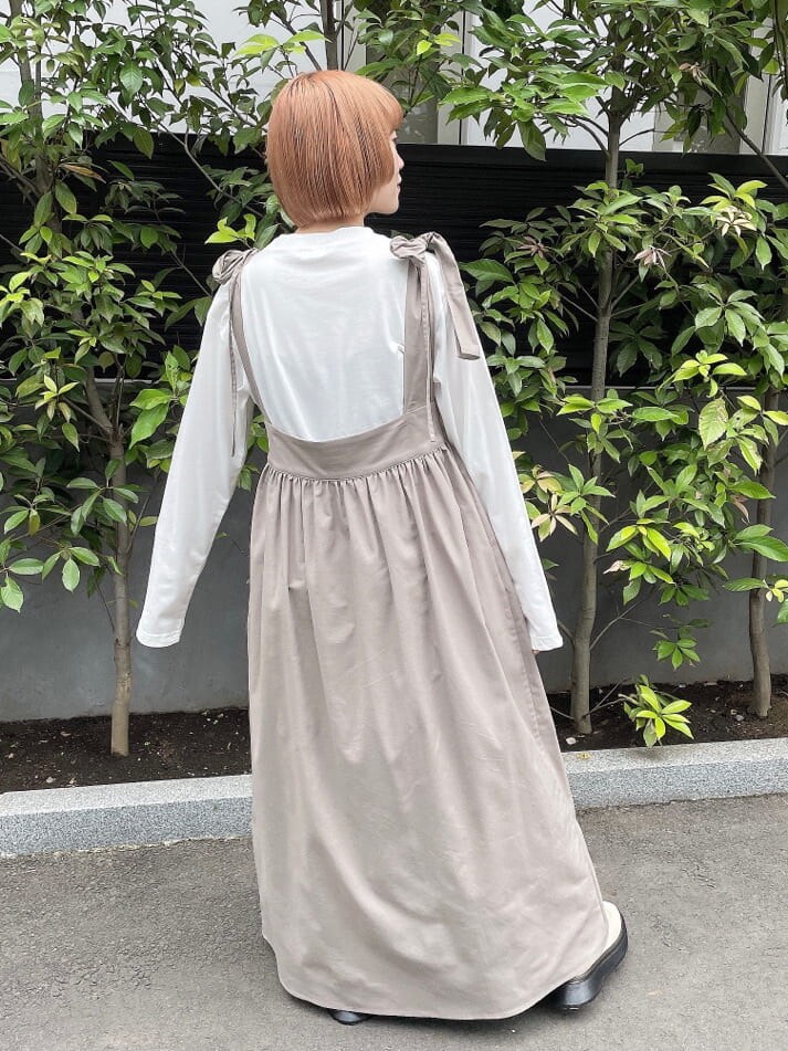 ホワイト系のブーツ、ブラウン系のスカート、ホワイト系のTシャツ/カットソーを着用したレディースの秋コーディネートの4枚目の写真