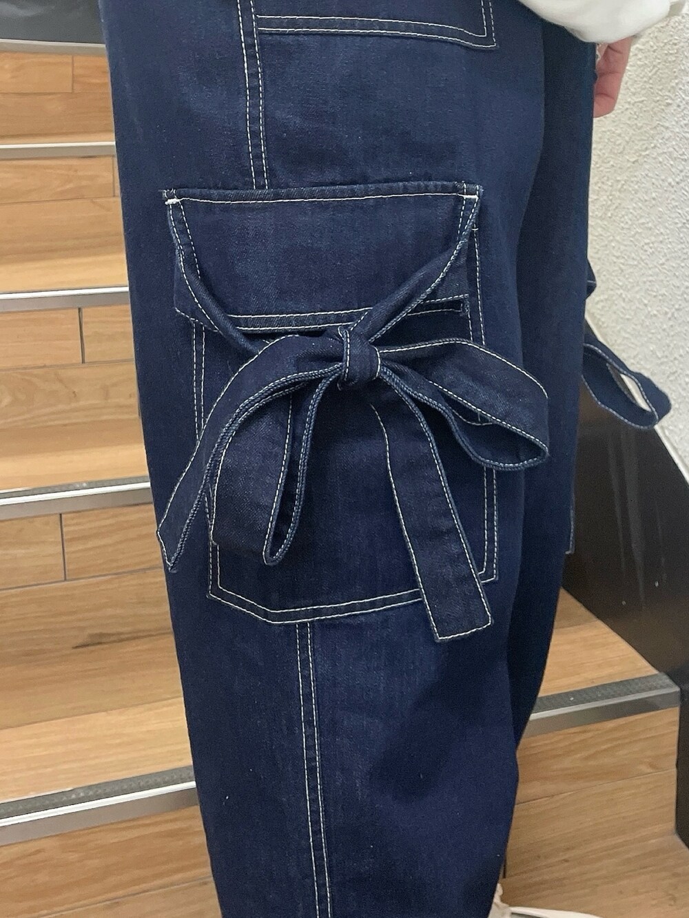 ブルー系のジャージ、ホワイト系のスウェット、ブルー系のデニムパンツを着用したレディースの春コーディネートの9枚目の写真