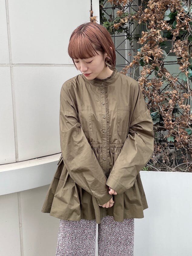 ブラック系のハンドバッグ、グリーン系のワンピース、ブラック系のパンプスを着用したレディースの秋コーディネートの3枚目の写真