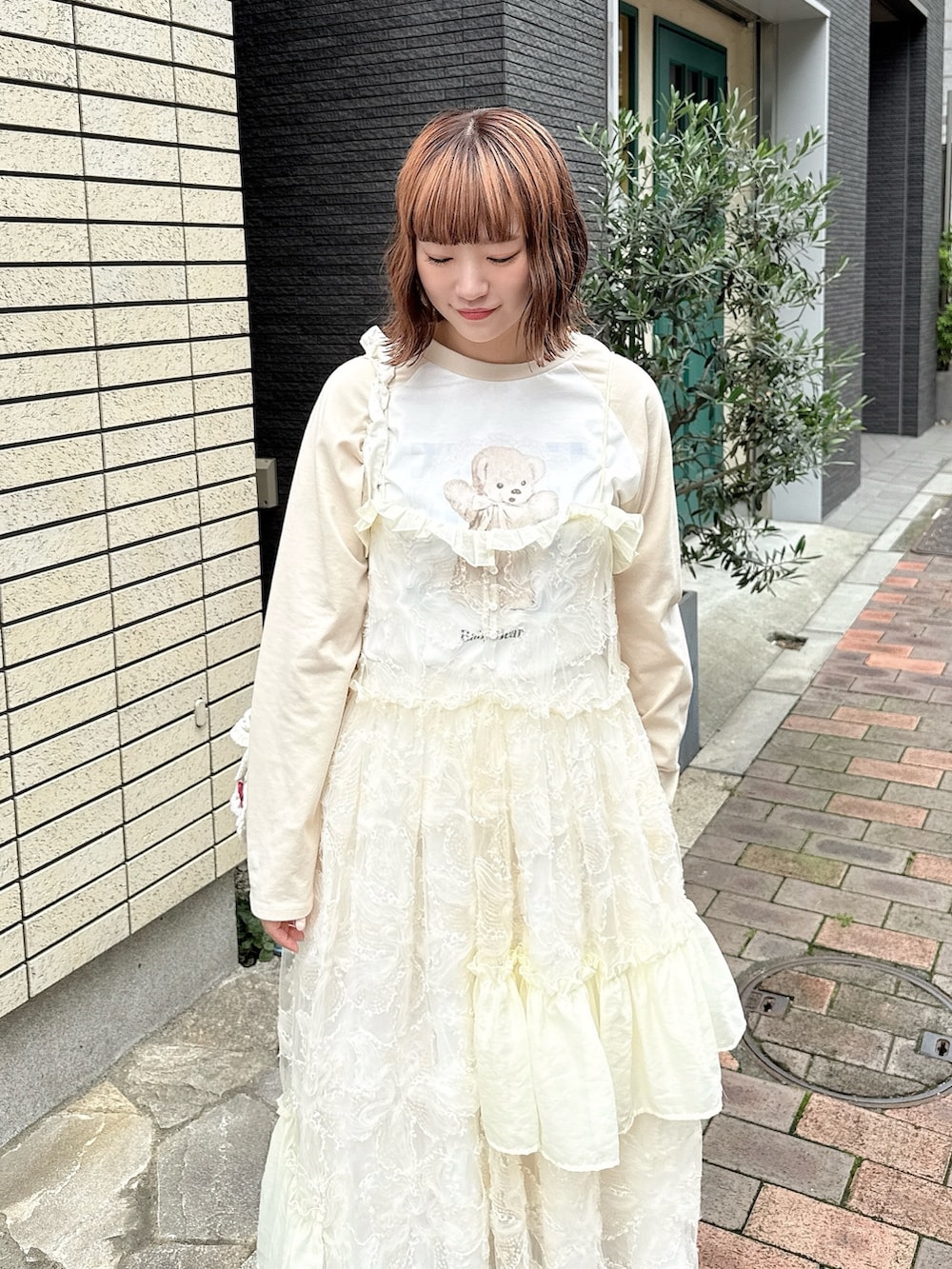 ベージュ系のTシャツ/カットソー、ホワイト系のワンピース、ホワイト系のスカートを着用したレディースの夏コーディネートの4枚目の写真