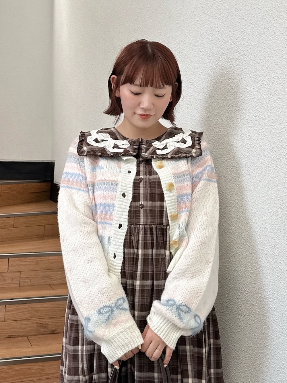 ホワイト系のカーディガン/ボレロ、ブラウン系のワンピース、ブラウン系のハンドバッグを着用したレディースの夏コーディネートの3枚目の写真
