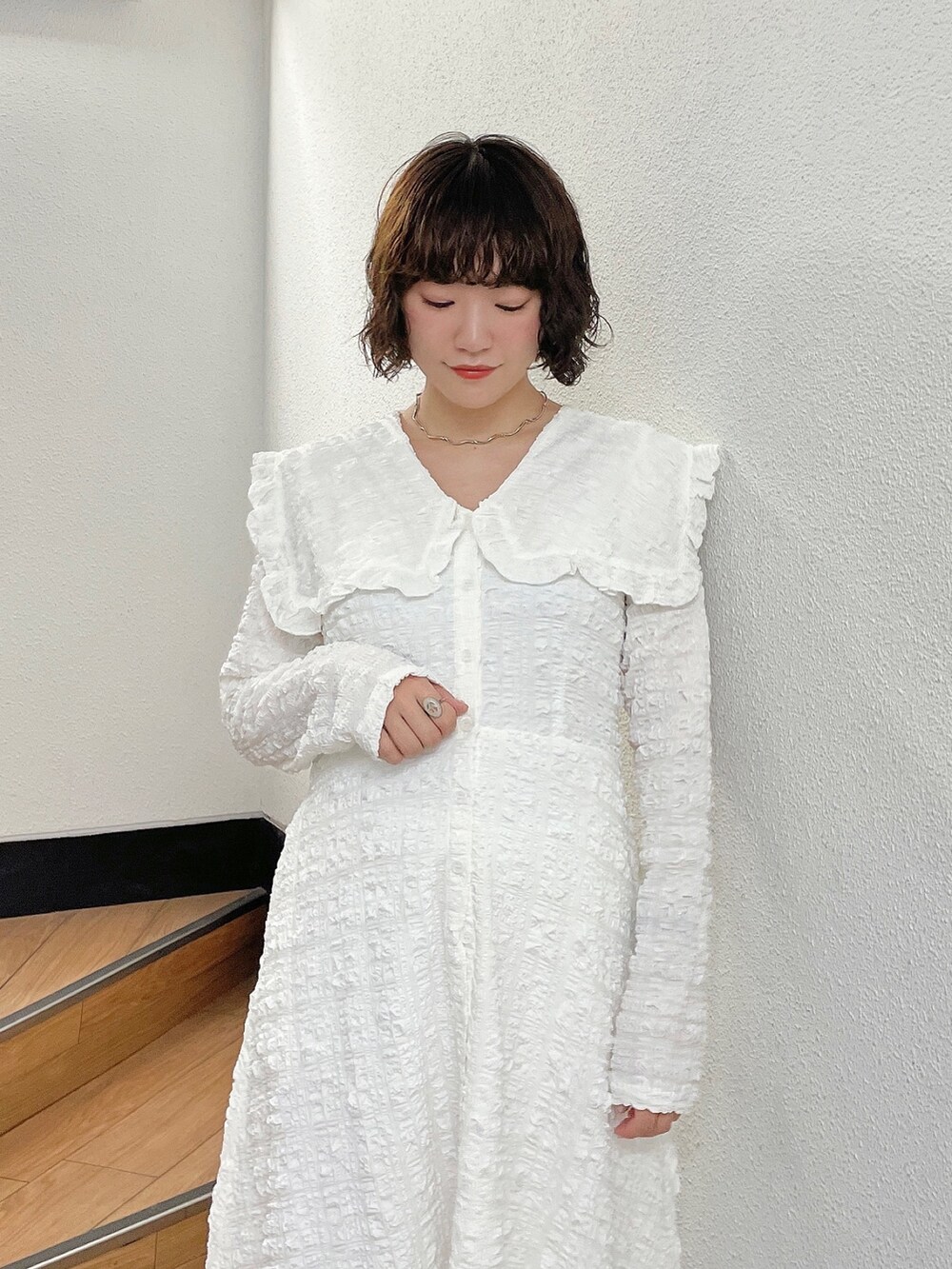 ホワイト系のワンピース、ベージュ系のブーツを着用したレディースの秋コーディネートの5枚目の写真