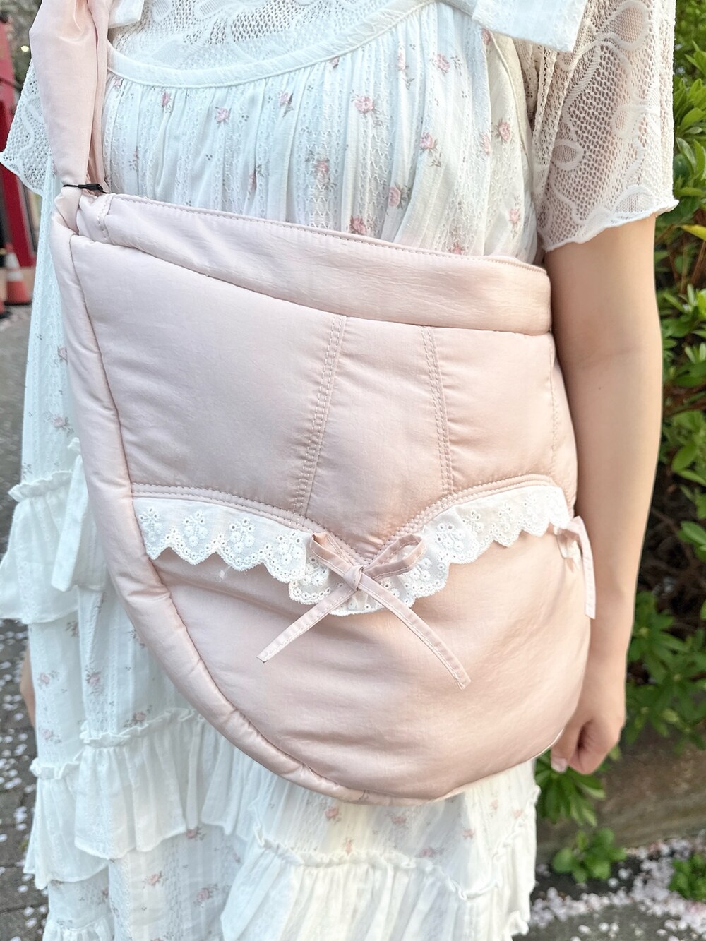 ピンク系のショルダーバッグ、ホワイト系のTシャツ/カットソー、ピンク系のワンピースを着用したレディースの春コーディネートの7枚目の写真