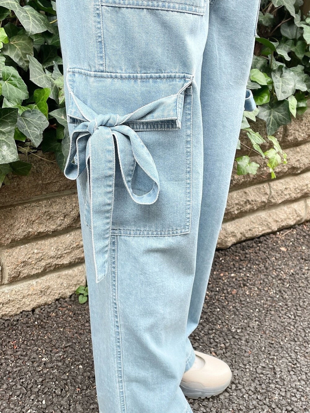 ブルー系のデニムパンツ、レッド系のカーディガン/ボレロ、ホワイト系のTシャツ/カットソーを着用したレディースの冬コーディネートの4枚目の写真