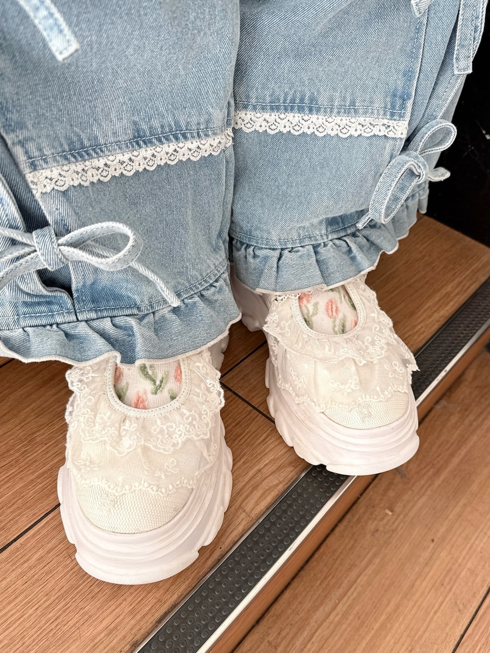 ホワイト系のブルゾン、ホワイト系のスウェット、ブルー系のデニムパンツを着用したレディースの冬コーディネートの10枚目の写真