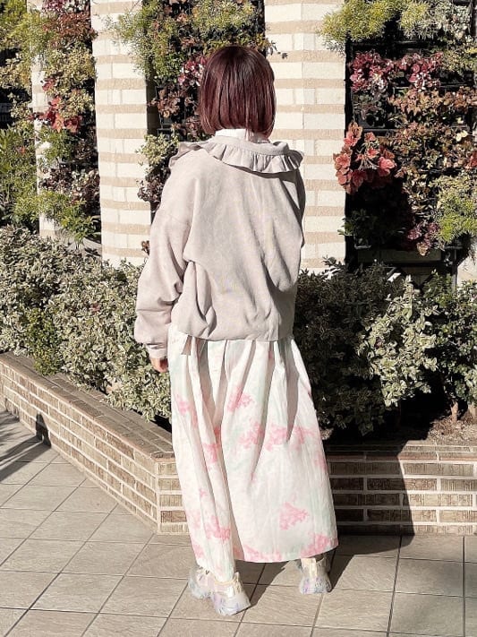 ベージュ系のその他アウター、ピンク系のワンピース、ホワイト系のスニーカーを着用したレディースの冬コーディネートの3枚目の写真