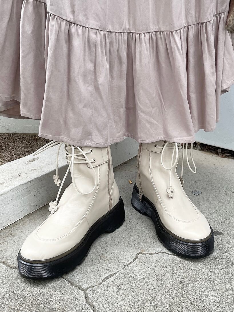 ホワイト系のブーツ、ピンク系のワンピース、ブラウン系のハンドバッグを着用したレディースの秋コーディネートの6枚目の写真